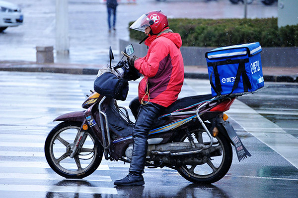 A food delivery man in Qingdao, Shandong province, checks his orders. (Photo/China Daily) A food delivery man in Qingdao, Shandong province, checks his orders. (Photo/China Daily)