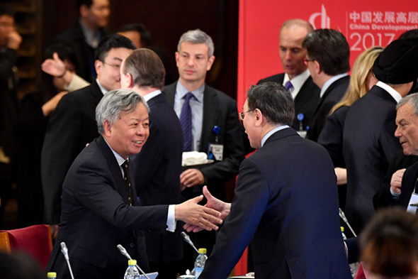 Asian Infrastructure Investment Bank (AIIB) President Jin Liqun (L) speaks with a guest during the China Development Forum (CDF) 2017 in Beijing, March 19, 2017. (Photo/Xinhua) Asian Infrastructure Investment Bank (AIIB) President Jin Liqun (L) speaks with a guest during the China Development Forum (CDF) 2017 in Beijing, March 19, 2017. (Photo/Xinhua)