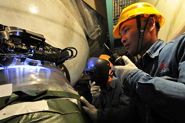 Technicians control an automatic welding operation of a nuclear reactor at the Ningde nuclear power plant in Fujian province. (Photo/Xinhua) Technicians control an automatic welding operation of a nuclear reactor at the Ningde nuclear power plant in Fujian province. (Photo/Xinhua)