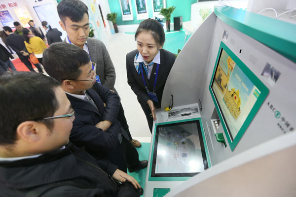 Vistors check out the booth of Agricultural Bank of China at the 12th International Financial Expo in Beijing. (Photo by A Qing/For China Daily) Vistors check out the booth of Agricultural Bank of China at the 12th International Financial Expo in Beijing. (Photo by A Qing/For China Daily)