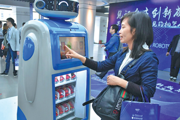 A woman interacts with a smart Magic Wand vendor in Guangzhou. (Photo by Zhu Yuanbin/China Daily) A woman interacts with a smart Magic Wand vendor in Guangzhou. (Photo by Zhu Yuanbin/China Daily)