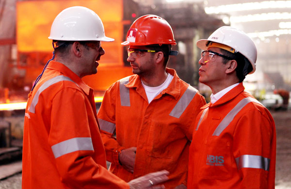 Hesteel Serbia employees discuss production techniques with a member of the Chinese management team. (Photo by Fu Jing/China Daily) Hesteel Serbia employees discuss production techniques with a member of the Chinese management team. (Photo by Fu Jing/China Daily)