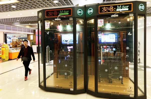 A man passes by two karaoke booths at Beijing Yintai Center in Beijing. (Photo by Feng Yongbin/China Daily) A man passes by two karaoke booths at Beijing Yintai Center in Beijing. (Photo by Feng Yongbin/China Daily)