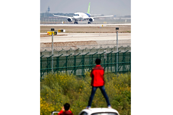 Fans watch C919, China's first homegrown big passenger jet, performing a high-speed taxiing test at the Pudong International Airport in Shanghai on Sunday. (Photo by Yin Liqin/For China Daily) Fans watch C919, China's first homegrown big passenger jet, performing a high-speed taxiing test at the Pudong International Airport in Shanghai on Sunday. (Photo by Yin Liqin/For China Daily)
