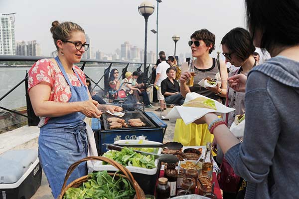 A woman sells British food from her startup on the Bund.Yang Yi / For China Daily A woman sells British food from her startup on the Bund.Yang Yi / For China Daily
