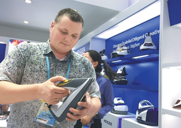A foreign merchant tries a steam iron at the Canton Fair, which ended on Friday in Guangzhou, Guangdong province. (Photo/China Daily) A foreign merchant tries a steam iron at the Canton Fair, which ended on Friday in Guangzhou, Guangdong province. (Photo/China Daily)