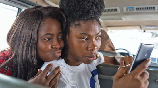 Two Nigerian women take a selfie with a Tecno smartphone made by Transsion Holdings, a Shenzhen-based manufacturer. Provided to China Daily