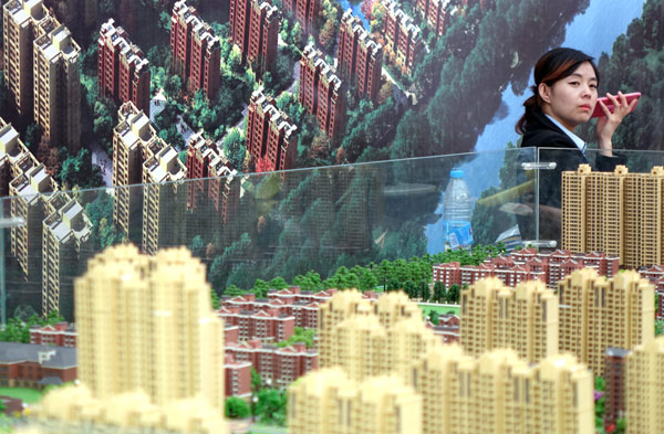 A saleswoman at a real estate show in Zhengzhou, Henan province. XINHUA A saleswoman at a real estate show in Zhengzhou, Henan province. XINHUA