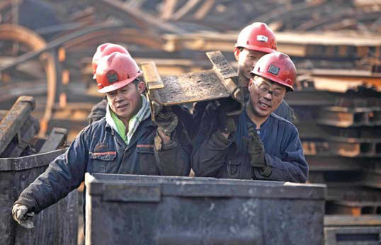 Miners carry parts at a colliery in Huaibei, Anhui province. Xie Zhengyi / For China Daily Miners carry parts at a colliery in Huaibei, Anhui province. Xie Zhengyi / For China Daily