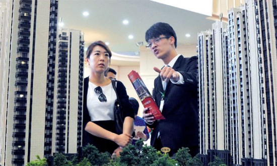 A potential buyer seeks information about property projects at a real estate expo in Shanghai. Yang Yi / For China Daily A potential buyer seeks information about property projects at a real estate expo in Shanghai. Yang Yi / For China Daily
