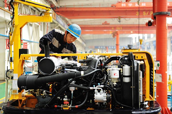 A worker assembles an excavator in a plant of Qingdao Lovol Excavator Co Ltd in Qingdao, Shandong province. (Photo/China Daily) A worker assembles an excavator in a plant of Qingdao Lovol Excavator Co Ltd in Qingdao, Shandong province. (Photo/China Daily)