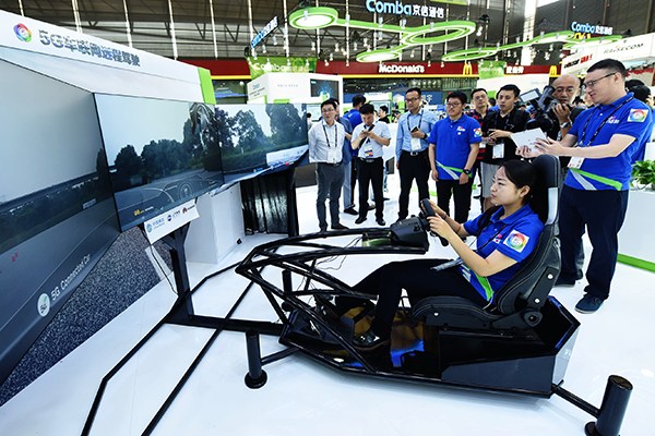 A woman demonstrates remote driving technology based on 5G during the 2017 Mobile World Congress in Shanghai, June 28. (Photo/China Daily) A woman demonstrates remote driving technology based on 5G during the 2017 Mobile World Congress in Shanghai, June 28. (Photo/China Daily)