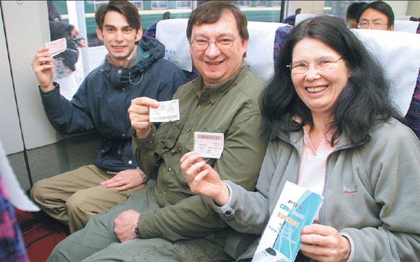 Some foreign passengers proudly show off their high-speed railway tickets during a CRH train ride to Beijing from Tianjin. (Photo by Cheng Zi / For China Daily) Some foreign passengers proudly show off their high-speed railway tickets during a CRH train ride to Beijing from Tianjin. (Photo by Cheng Zi / For China Daily)