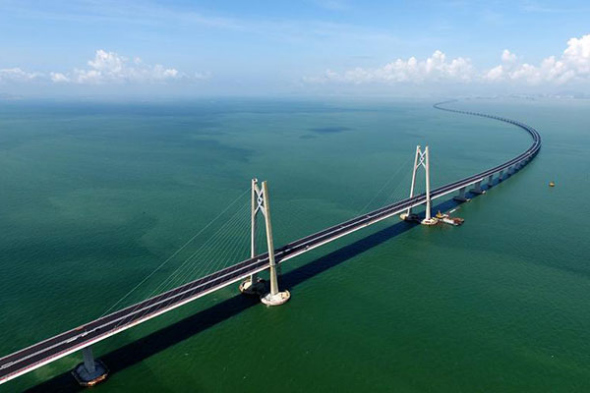 A section of the Hong Kong-Zhuhai-Macao Bridge is seen on July 7, 2017. An underground tunnel section of the long-awaited Hong Kong-Zhuhai-Macao Bridge was completed on Friday, marking the end of construction of the main structure for the world's longest cross-sea bridge.(Photo/Xinhua) A section of the Hong Kong-Zhuhai-Macao Bridge is seen on July 7, 2017. An underground tunnel section of the long-awaited Hong Kong-Zhuhai-Macao Bridge was completed on Friday, marking the end of construction of the main structure for the world's longest cross-sea bridge.(Photo/Xinhua)