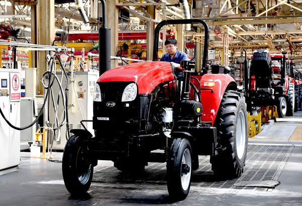 A tractor comes off the production line of YTO Group Corp in Luoyang, Henan province. (Photo/Xinhua) A tractor comes off the production line of YTO Group Corp in Luoyang, Henan province. (Photo/Xinhua)