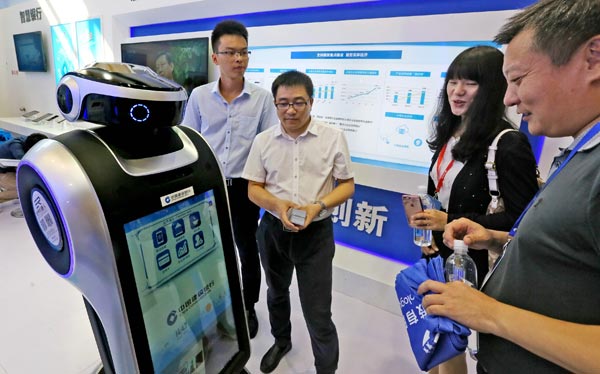 A service robot rolled out by China Construction Bank interacts with visitors at a financial fair in Beijing. (Photo by Lei Kesi/For China Daily) A service robot rolled out by China Construction Bank interacts with visitors at a financial fair in Beijing. (Photo by Lei Kesi/For China Daily)