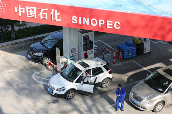 Cars refuel at a Sinopec gas station in Qingdao, Shandong province. Cars refuel at a Sinopec gas station in Qingdao, Shandong province.