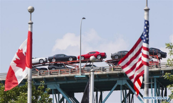 An auto transport carrier crosses the Ambassador Bridge heading to the United States in Windsor, Ontario, Canada, on Aug. 16, 2017.(Xinhua/Zou Zheng) An auto transport carrier crosses the Ambassador Bridge heading to the United States in Windsor, Ontario, Canada, on Aug. 16, 2017.(Xinhua/Zou Zheng)