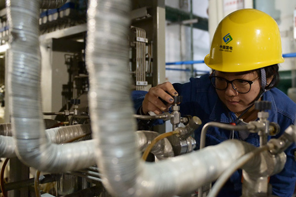 A technician of China Guodian Corp checks facilities in Lanzhou, capital of Gansu province. The merger between China Guodian Corp and Shenhua Group has been approved. (Photo/Xinhua) A technician of China Guodian Corp checks facilities in Lanzhou, capital of Gansu province. The merger between China Guodian Corp and Shenhua Group has been approved. (Photo/Xinhua)