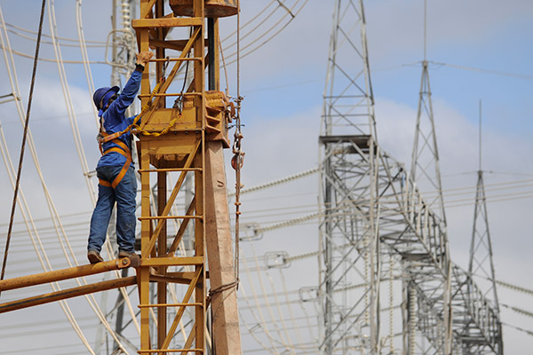 A worker of State Grid Corp of China checks facilities at a transformer substation in Brazil. (Photo/Xinhua)