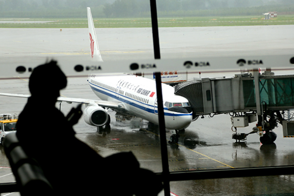 A passenger waits for his flight at Beijing Capital International Airport. (Photo/Xinhua) A passenger waits for his flight at Beijing Capital International Airport. (Photo/Xinhua)