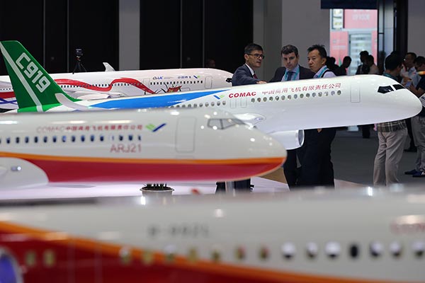 Visitors look at a model of the Chinese-built C919 passenger plane at the 17th China Aviation Expo in Beijing on Tuesday. WANG ZHUANGFEI/CHINA DAILY Visitors look at a model of the Chinese-built C919 passenger plane at the 17th China Aviation Expo in Beijing on Tuesday. WANG ZHUANGFEI/CHINA DAILY