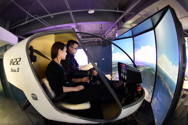 Working staff operate a flight simulator at the virtual reality technology center of the service outsourcing industry base in Langfang, Hebei province. (Photo/Xinhua) Working staff operate a flight simulator at the virtual reality technology center of the service outsourcing industry base in Langfang, Hebei province. (Photo/Xinhua)