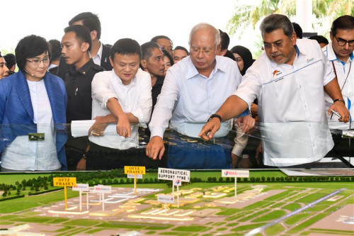 Malaysian Prime Minister Najib Razak (2nd R, Front), Alibaba founder and Executive Chairman Jack Ma (2nd L, Front) view a model of Alibaba's logistics affiliate Cainiao in Sepang, Malaysia, on Nov. 3, 2017. Alibaba announced here on Friday to launch the Electronic World Trade Platform (eWTP) where people can buy global and sell global. (Xinhua/Chong Voon Chung) Malaysian Prime Minister Najib Razak (2nd R, Front), Alibaba founder and Executive Chairman Jack Ma (2nd L, Front) view a model of Alibaba's logistics affiliate Cainiao in Sepang, Malaysia, on Nov. 3, 2017. Alibaba announced here on Friday to launch the Electronic World Trade Platform (eWTP) where people can buy global and sell global. (Xinhua/Chong Voon Chung)