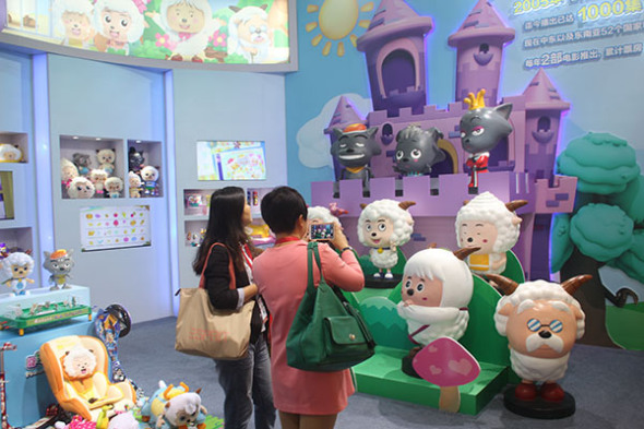 Visitors take photographs of Chinese cartoon characters, Xiyangyang (Happy Sheep) and Huitailang (Gray Wolf), created by Alpha Group at a toy exhibition in Shanghai.XING YUN/CHINA DAILY Visitors take photographs of Chinese cartoon characters, Xiyangyang (Happy Sheep) and Huitailang (Gray Wolf), created by Alpha Group at a toy exhibition in Shanghai.XING YUN/CHINA DAILY