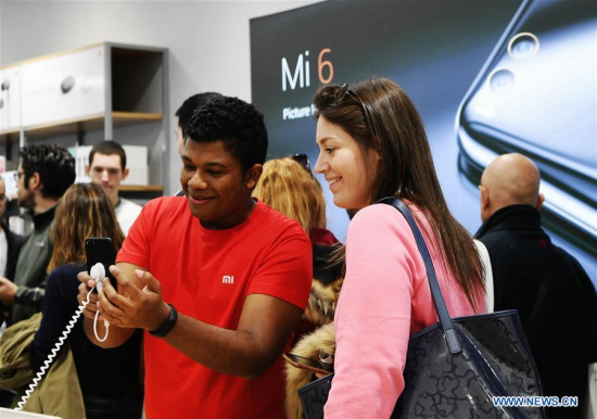A staff member introduces a Xiaomi product to a customer at a store in Madrid, capital of Spain, on Nov. 11, 2017. Xiaomi, one of the leading high-tech enterprises of China, opened on Saturday morning its two stores via its authorized re-sellers in Madrid. (Xinhua/Guo Qiuda) A staff member introduces a Xiaomi product to a customer at a store in Madrid, capital of Spain, on Nov. 11, 2017. Xiaomi, one of the leading high-tech enterprises of China, opened on Saturday morning its two stores via its authorized re-sellers in Madrid. (Xinhua/Guo Qiuda)