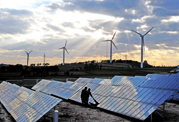 Workers check equipment at a wind farm in Shanxi province. (Photo/Xinhua) Workers check equipment at a wind farm in Shanxi province. (Photo/Xinhua)