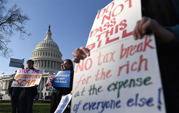 People protest against tax reform on Capitol hill in Washington DC, the United States, on Dec 1, 2017. The US Senate on Saturday morning narrowly passed the Republican bill to overhaul the tax code in decades, moving one step closer to the first major legislative victory of the Trump administration and congressional Republicans. (Photo/Xinhua) People protest against tax reform on Capitol hill in Washington DC, the United States, on Dec 1, 2017. The US Senate on Saturday morning narrowly passed the Republican bill to overhaul the tax code in decades, moving one step closer to the first major legislative victory of the Trump administration and congressional Republicans. (Photo/Xinhua)