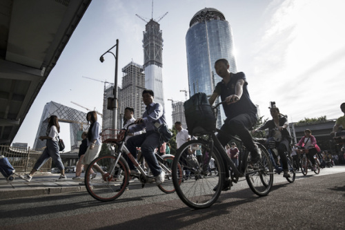 Cyclists ride along a road near the China Central Television headquarters in Beijing. There is a lot of interest in converting shopping complexes and similar realty into office spaces in Beijing this year. (Photo provided to China Daily) Cyclists ride along a road near the China Central Television headquarters in Beijing. There is a lot of interest in converting shopping complexes and similar realty into office spaces in Beijing this year. (Photo provided to China Daily)