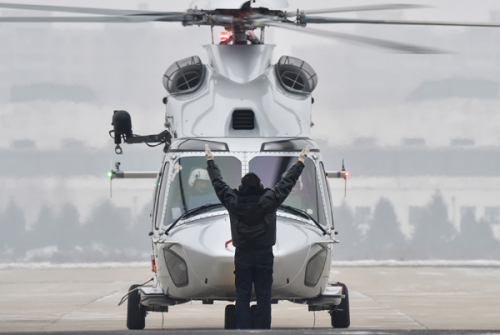 A ground personnel clears an AC352 helicopter, designed by the Aviation Industry Corporation of China, for take off. (Photo/Xinhua) A ground personnel clears an AC352 helicopter, designed by the Aviation Industry Corporation of China, for take off. (Photo/Xinhua)