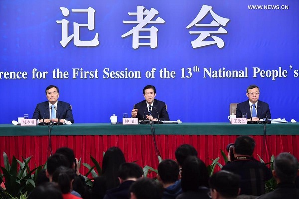 Chinese Minister of Commerce Zhong Shan (C), Vice Minister of Commerce and Deputy China International Trade Representative Wang Shouwen (R), and Vice Minister of Commerce Qian Keming attend a press conference on opening up on all fronts and promoting high quality development of commercial business on the sidelines of the first session of the 13th National People's Congress in Beijing, capital of China, March 11, 2018. (Xinhua/Li Xin)