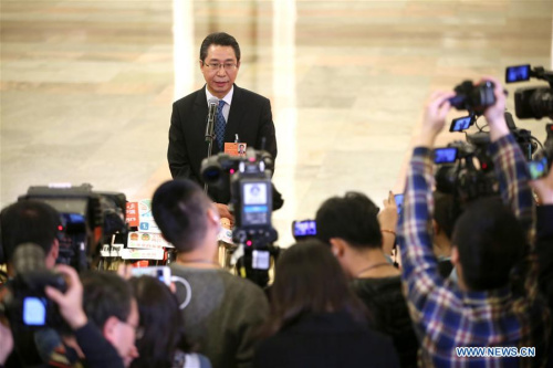 Shen Changyu, director of the State Intellectual Property Office, answers media questions after the fourth plenary meeting of the first session of the 13th National People's Congress at the Great Hall of the People in Beijing, March 13, 2018. (Photo/Xinhua)