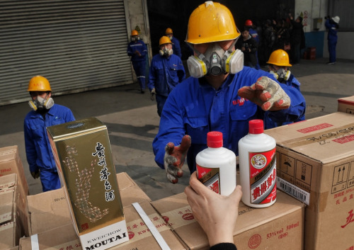 Inspectors take inventory of seized fake Moutai liquor that is about to be destroyed in Beijing on Tuesday. (WANG JIANING/FOR CHINA DAILY) Inspectors take inventory of seized fake Moutai liquor that is about to be destroyed in Beijing on Tuesday. (WANG JIANING/FOR CHINA DAILY)