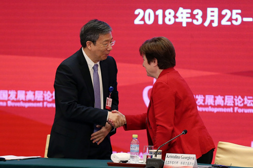 Yi Gang, newly elected governor of the People's Bank of China, greets Kristalina Georgieva, chief executive officer of the World Bank, at the China Development Forum 2018 in Beijing on Sunday. (Photo/CHINA DAILY) Yi Gang, newly elected governor of the People's Bank of China, greets Kristalina Georgieva, chief executive officer of the World Bank, at the China Development Forum 2018 in Beijing on Sunday. (Photo/CHINA DAILY)