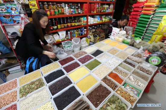 A grocer sells grains at a market in Nantong City of east China's Jiangsu Province, April 11, 2018. (Xinhua/Xu Congjun) A grocer sells grains at a market in Nantong City of east China's Jiangsu Province, April 11, 2018. (Xinhua/Xu Congjun)