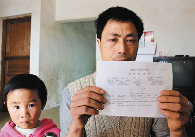 Liu Hongdai, a resident of Dongtang township, holds up a body check sheet of one of his granddaughters who had been diagnosed with excessive lead in blood on Wednesday. Provided to China Daily 