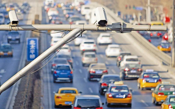 Surveillance cameras are seen over a road in Beijing. (File photo) Surveillance cameras are seen over a road in Beijing. (File photo)