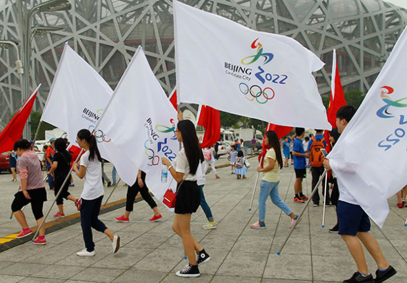 A group of volunteers walk through the square at the Bird's Nest, the landmark stadium for the 2008 Olympic Games, on Thursday, to show their support for China's bid to be the host of the 2022 Winter Olympics.(Photo: China Daily/Zhu Xingxin) A group of volunteers walk through the square at the Bird's Nest, the landmark stadium for the 2008 Olympic Games, on Thursday, to show their support for China's bid to be the host of the 2022 Winter Olympics.(Photo: China Daily/Zhu Xingxin)