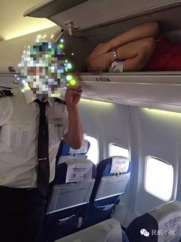 A female attendant of Kunming Airlines is seen lying on the narrow luggage rack. (Photo/yunnan.cn) A female attendant of Kunming Airlines is seen lying on the narrow luggage rack. (Photo/yunnan.cn)