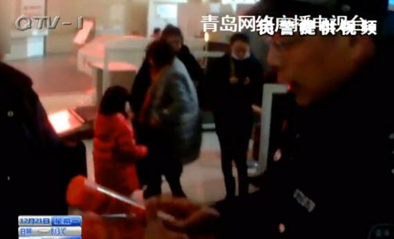 A policeman shows the dangerous signal flares found in a passenger's luggage. (Photo/Qingdao TV) A policeman shows the dangerous signal flares found in a passenger's luggage. (Photo/Qingdao TV)