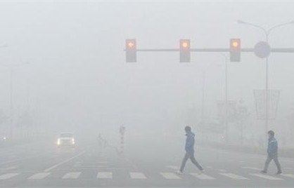 People walk across an intersection during a smoggy day. (File photo) People walk across an intersection during a smoggy day. (File photo)