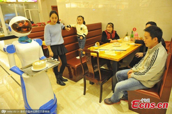 A robot waitress about 1.5 meters works for a Hong Kong style tea restaurant in Haikou, Hainan Province, in August 3,2015.Her Life is about 7 to 10 years, after an electric charge she can keep working 12 hours. She can speak, serve food, sing and greet. (CNS photo/Luo Yunfei) A robot waitress about 1.5 meters works for a Hong Kong style tea restaurant in Haikou, Hainan Province, in August 3,2015.Her Life is about 7 to 10 years, after an electric charge she can keep working 12 hours. She can speak, serve food, sing and greet. (CNS photo/Luo Yunfei)