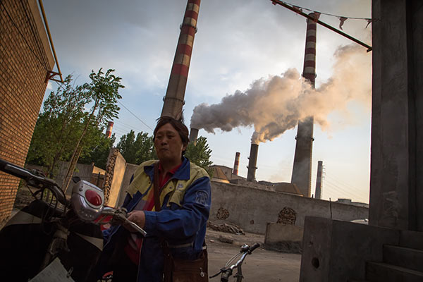 A resident reacts to the air in Handan, Hebei province, in April. The city, known for its highly polluting industries, such as steel, is facing an industrial transformation. File photo A resident reacts to the air in Handan, Hebei province, in April. The city, known for its highly polluting industries, such as steel, is facing an industrial transformation. File photo