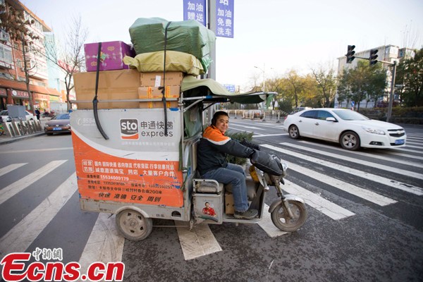 A delivery man with STO Express drives a tricycle to deliver packages. (File photo/China News Service) A delivery man with STO Express drives a tricycle to deliver packages. (File photo/China News Service)