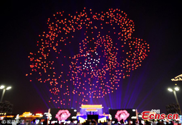 Drones make a formation in the air over the illuminated Yongning Gate in Xi'an City, capital of Northwest China's Shaanxi Province, May 1, 2018. (Photo/VCG) Drones make a formation in the air over the illuminated Yongning Gate in Xi'an City, capital of Northwest China's Shaanxi Province, May 1, 2018. (Photo/VCG)