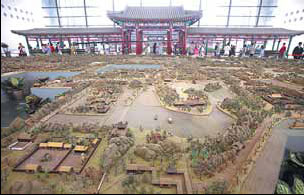 Tourists visit a miniature of the old Summer Palace in the Museum of Chinese Gardens inside the garden expo. 